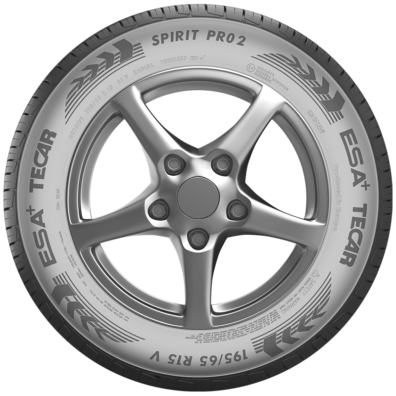 Close-up of a car wheel with a silver five-spoke alloy rim and a TECAR private label tire featuring the inscription SPIRIT PRO2 and the tire size 195/65 R15 91V on the sidewall.